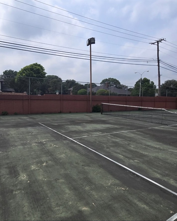 Worn tennis court before conversion in Plano Texas